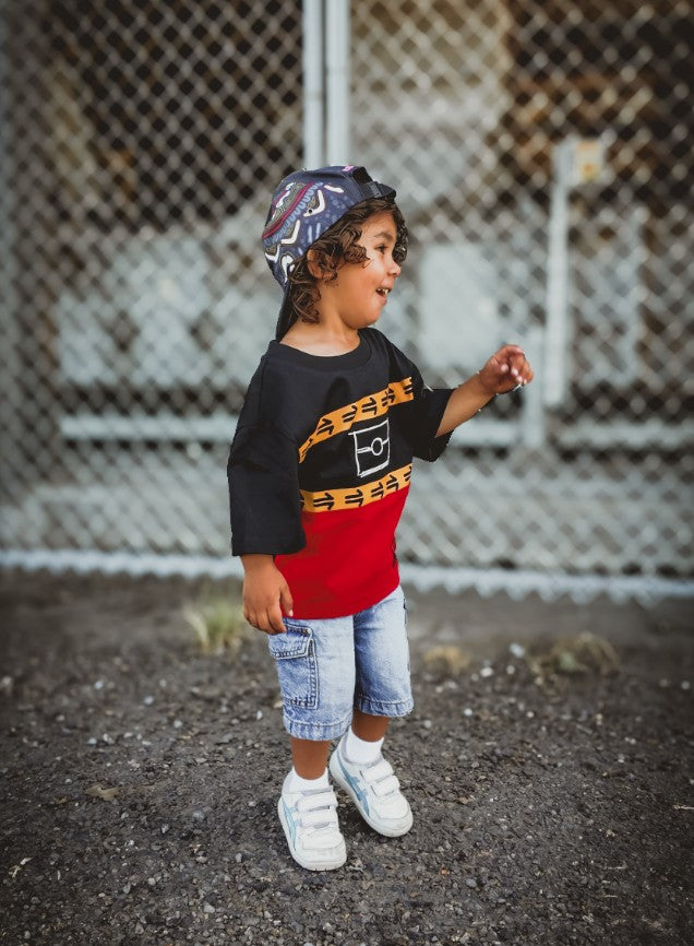 Child wearing the Ngurrbul Heavy tee, side view